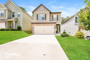 Union City house for rent - a white driveway in front of a house with a garage door