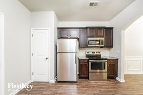 Union City house for rent - a kitchen with stainless steel appliances and brown cabinets