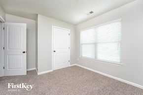 Union City house for rent - a bedroom with a door and a window and a carpeted floor