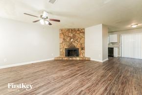 Lithonia house for rent - the living room with wood flooring and a stone fireplace