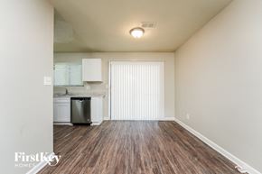 Lithonia house for rent - an empty living room with wood flooring and a kitchen