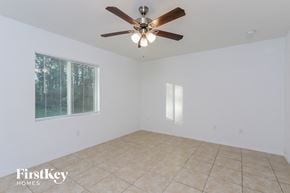 North Port house for rent - a living room with a ceiling fan and a tiled floor