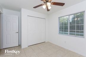 North Port house for rent - a bedroom with a ceiling fan and a door to a closet