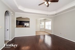 Bessemer house for rent - A spacious room with a ceiling fan and wooden flooring.