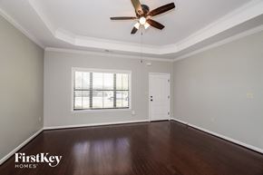 Bessemer house for rent - A room with a ceiling fan and wooden floors.
