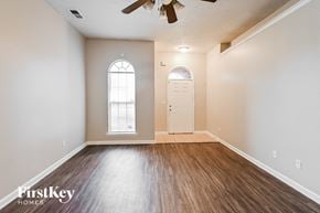 Memphis house for rent - A room with wooden floors and a ceiling fan.