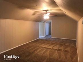 Fort Worth house for rent - a living room with a ceiling fan and a carpeted floor