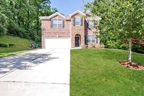 Charlotte house for rent - a brick house with a white garage door and a lawn