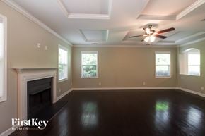 Charlotte house for rent - the living room with the fireplace and ceiling fan