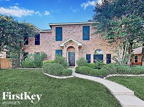 Arlington house for rent - the front of a brick house with green grass and a walkway