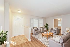 Kansas City house for rent - A living room with a couch, chairs, and a coffee table.