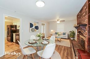 Kansas City house for rent - A dining room with a glass table and white chairs.