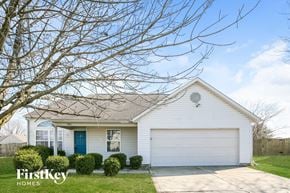 Indianapolis house for rent - A white house with a blue door and a garage door is for sale.