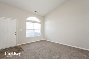 Indianapolis house for rent - A room with a carpeted floor and a door is shown.