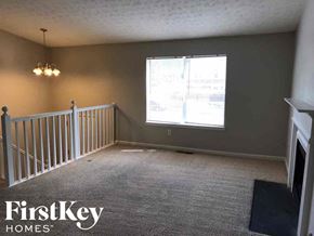 Stone Mountain house for rent - A room with a carpeted floor and a window with a view of buildings outside.
