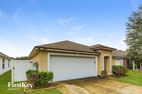 Jacksonville house for rent - A house with a brown roof and a white garage door is for sale.
