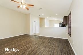 Jacksonville house for rent - A spacious room with a ceiling fan and wooden flooring.