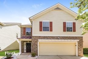 Atlanta house for rent - a white and brick house with a garage door