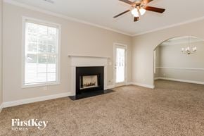 Atlanta house for rent - a living room with a fireplace and a ceiling fan
