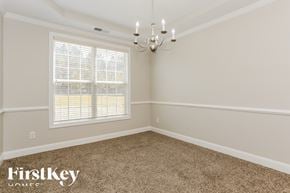 Atlanta house for rent - a empty dining room with a chandelier and a window