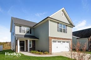 Clemmons house for rent - A house with a garage door that says FirstKey Homes.