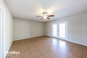 Phoenix house for rent - A room with a ceiling fan and tile flooring.