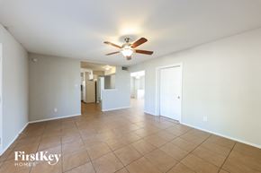 Phoenix house for rent - A spacious room with a ceiling fan and tiled flooring.