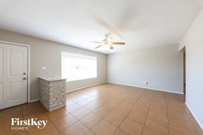 Phoenix house for rent - A room with a ceiling fan and tile flooring.