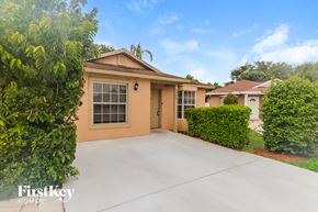 Boynton Beach house for rent - a home with a driveway and a garage door