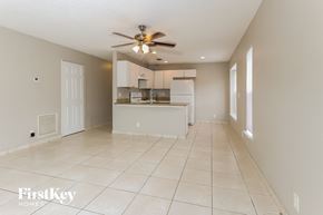 Boynton Beach house for rent - an empty kitchen and living room with a ceiling fan