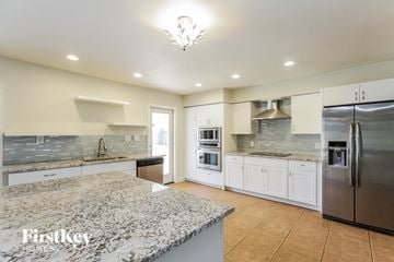 Tempe house for rent - a large kitchen with marble counter tops and stainless steel appliances