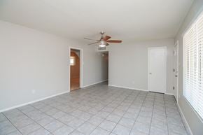 Phoenix house for rent - A room with a ceiling fan and tiled flooring.