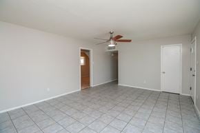 Phoenix house for rent - A room with a ceiling fan and tile flooring.