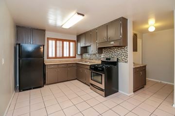Phoenix house for rent - A kitchen with black appliances and brown cabinets.