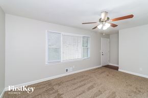 Acworth house for rent - A room with a carpet floor, a ceiling fan, and a window with blinds.