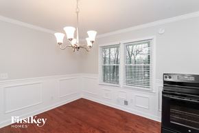 Acworth house for rent - A chandelier hangs over a white-walled room with wood flooring.