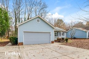 Charlotte house for rent - A blue house with a white garage door is for sale.