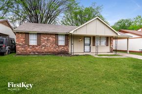 Memphis house for rent - a home with a lawn and a car parked in front of it