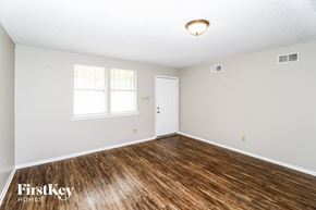 Memphis house for rent - a living room with a wooden floor and white walls and a white door