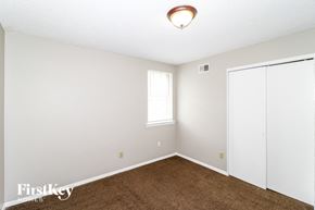 Memphis house for rent - a bedroom with white walls and carpet and a window and a closet