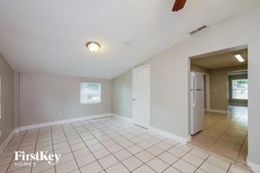 Hollywood house for rent - A spacious empty room with a fan and a window.