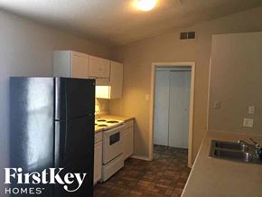 Memphis house for rent - an empty kitchen with a refrigerator and a sink