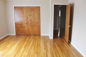 Indianapolis house for rent - a living room with a wooden floor and a wooden door