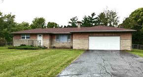 Indianapolis house for rent - a brick house with a white garage door