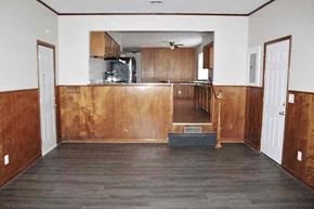 Indianapolis house for rent - a living room with wooden floors and a kitchen