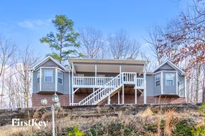Pinson house for rent - a blue house with a white porch and stairs
