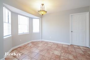 Pinson house for rent - a dining room with a large window and a door and a chandelier
