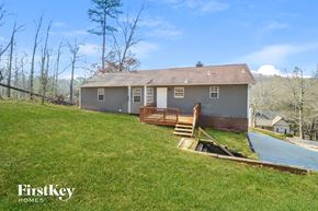 Pinson house for rent - a house on a hill with a deck and a pool