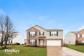 Indianapolis house for rent - a home with a white garage door and a brick house