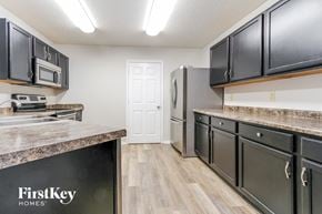 Indianapolis house for rent - a kitchen with stainless steel appliances and granite counter tops